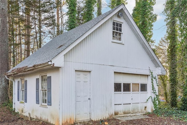 view of property exterior featuring an outbuilding and a garage