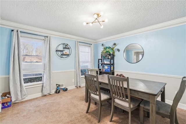 carpeted dining space with ornamental molding, a notable chandelier, and a textured ceiling