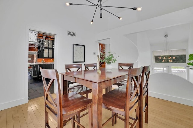 2683 Tritt Springs Trce NE, Marietta, GA 30062 - dining area with light wood-style flooring and a chandelier