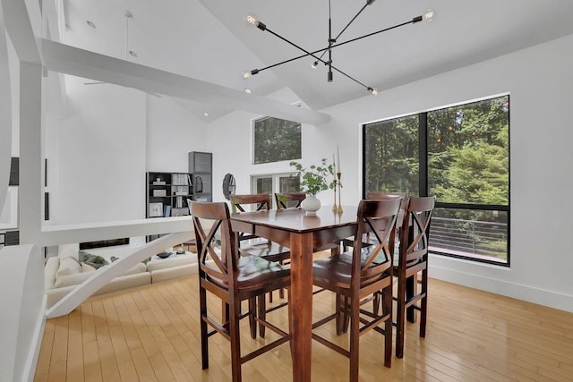 2683 Tritt Springs Trce NE, Marietta, GA 30062 - dining area with high vaulted ceiling, light wood finished floors, and a chandelier
