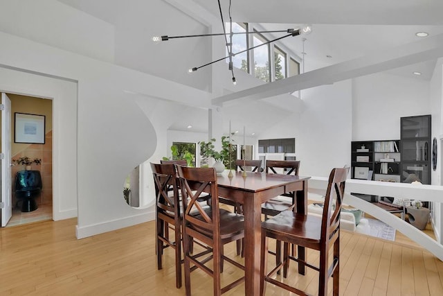 2683 Tritt Springs Trce NE, Marietta, GA 30062 - dining space with light wood-style flooring, high vaulted ceiling, a chandelier, and beam ceiling