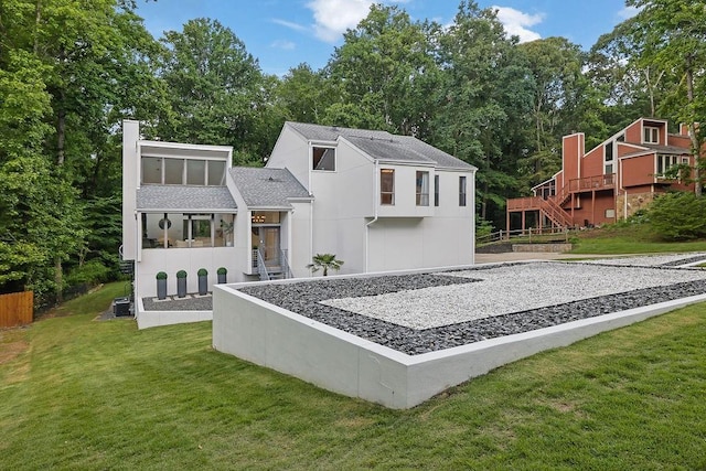 2683 Tritt Springs Trce NE, Marietta, GA 30062 - back of property featuring a lawn, a shingled roof, stairway, and a chimney