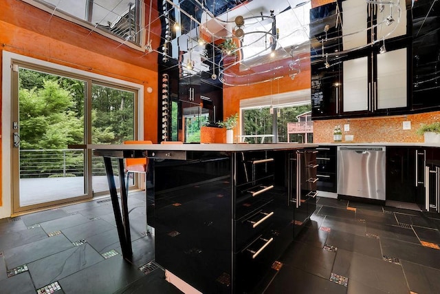 2683 Tritt Springs Trce NE, Marietta, GA 30062 - kitchen featuring stainless steel dishwasher, dark cabinets, plenty of natural light, and backsplash