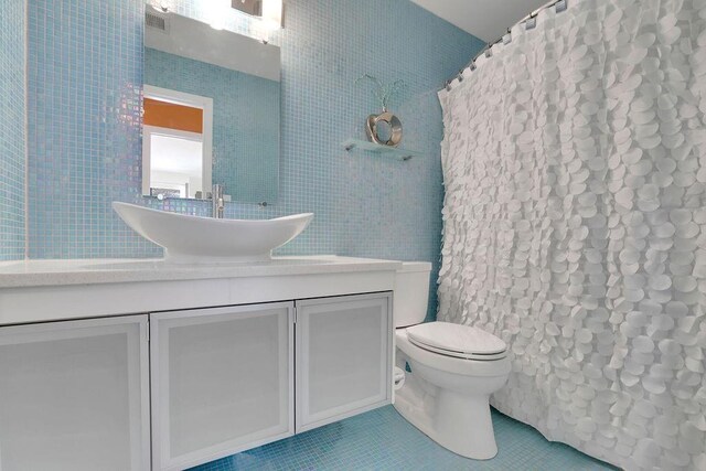 2683 Tritt Springs Trce NE, Marietta, GA 30062 - bathroom with tile patterned floors, tile walls, vanity, and a shower with curtain