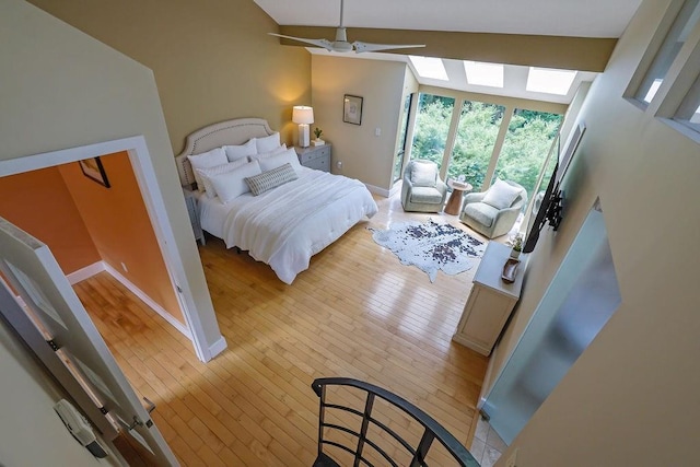 2683 Tritt Springs Trce NE, Marietta, GA 30062 - bedroom with light wood-type flooring, lofted ceiling, a ceiling fan, and a skylight