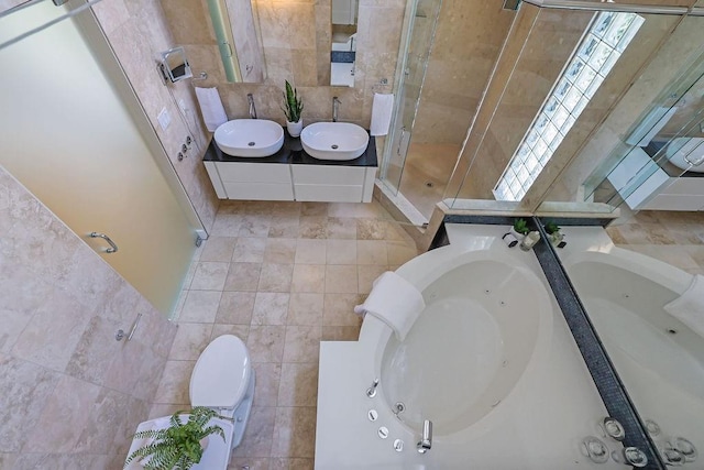 2683 Tritt Springs Trce NE, Marietta, GA 30062 - bathroom featuring tile walls, a tub with jets, a stall shower, double vanity, and tile patterned floors