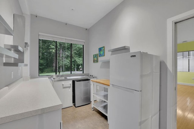 2683 Tritt Springs Trce NE, Marietta, GA 30062 - kitchen with freestanding refrigerator, open shelves, white cabinets, and fridge