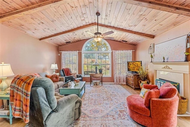 living room featuring vaulted ceiling with beams, a fireplace, wood finished floors, and wooden ceiling