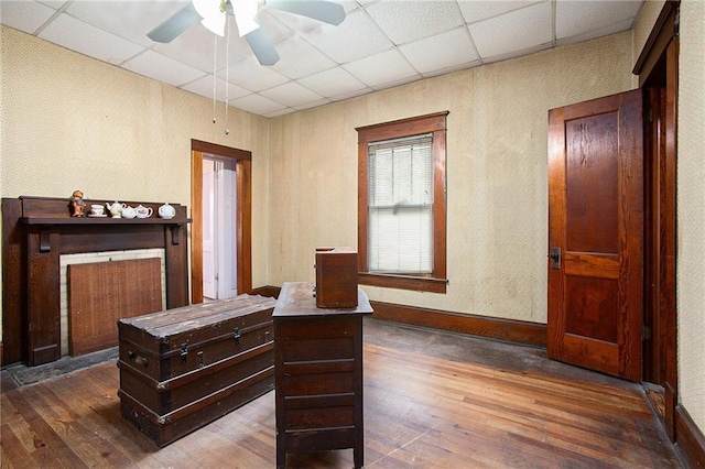 interior space featuring a drop ceiling and dark wood-type flooring