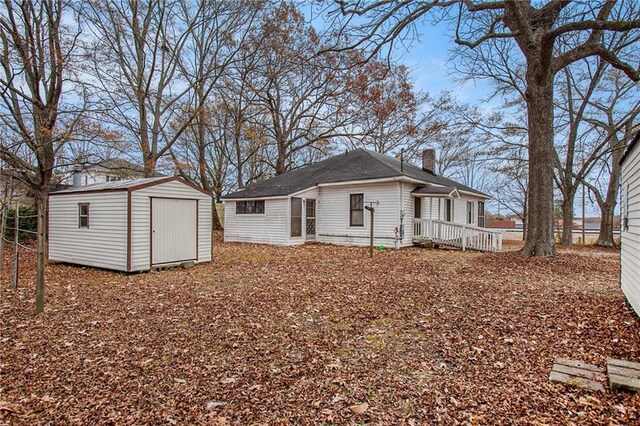 back of property featuring a storage shed