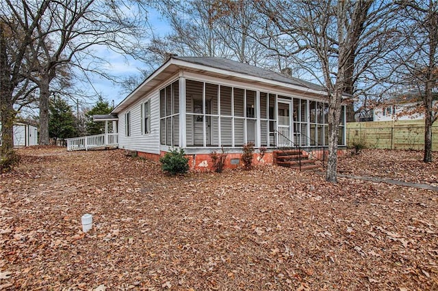 view of front of home with a storage shed