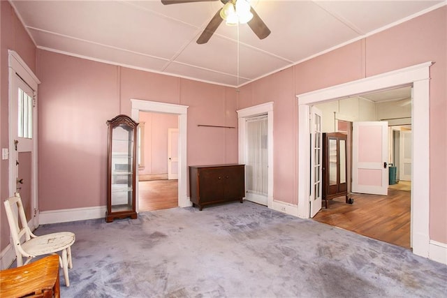 interior space featuring hardwood / wood-style flooring, ceiling fan, and crown molding