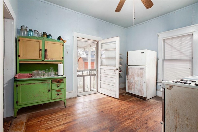 kitchen featuring wood-type flooring, white appliances, ceiling fan, and green cabinetry