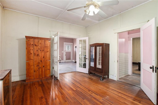 interior space with ceiling fan, french doors, and wood-type flooring