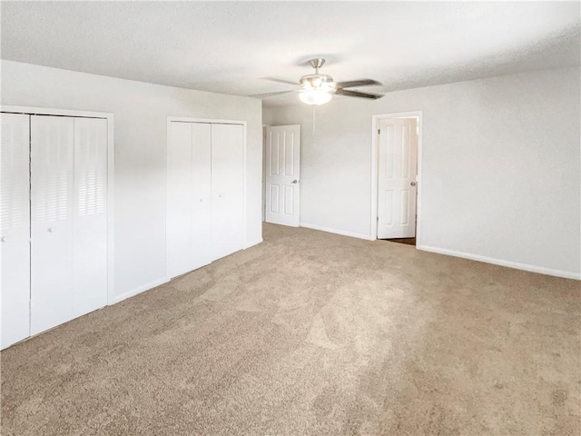 6354 Shannon Pkwy Unit 8B, Union City, GA 30291 - unfurnished bedroom featuring carpet, multiple closets, and a ceiling fan