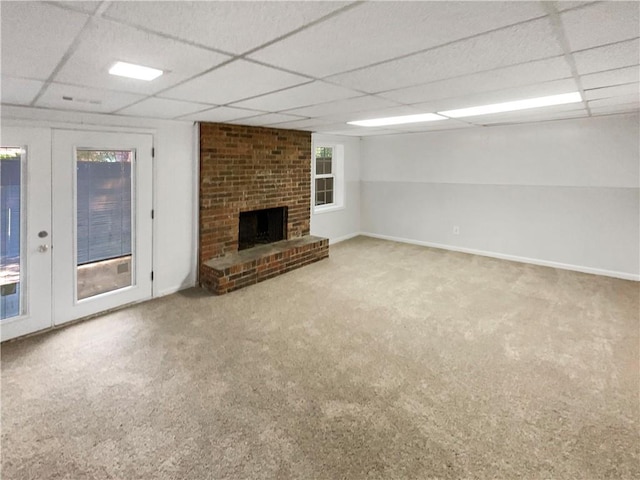 6354 Shannon Pkwy Unit 8B, Union City, GA 30291 - unfurnished living room featuring a paneled ceiling, carpet, a brick fireplace, and french doors
