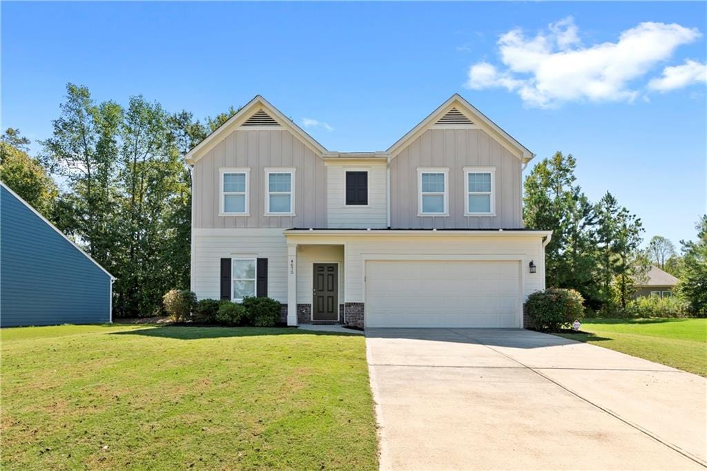 view of front of property featuring a garage and a front lawn