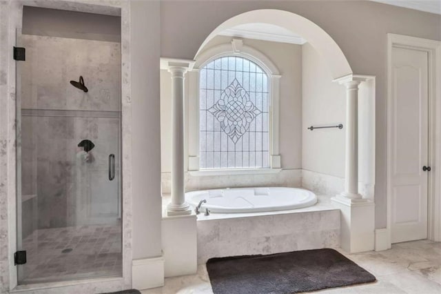 bathroom featuring marble finish floor, a shower stall, a bath, ornate columns, and crown molding