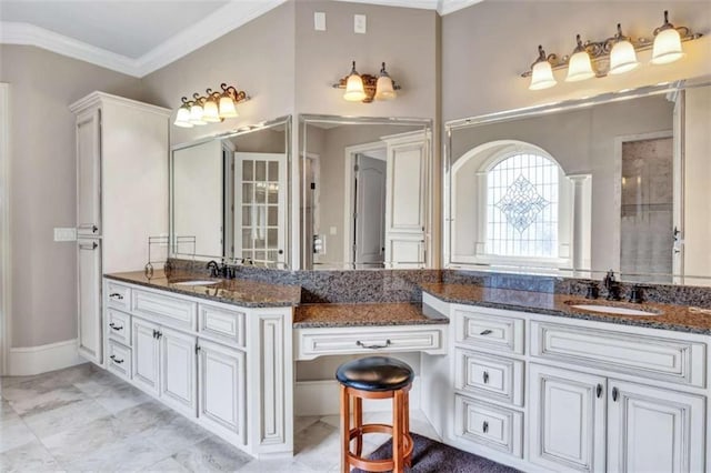 bathroom with crown molding, vanity, and baseboards