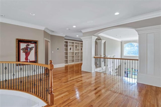 hall with recessed lighting, wood finished floors, decorative columns, and crown molding