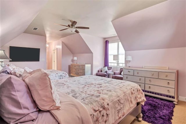 carpeted bedroom featuring vaulted ceiling, ceiling fan, and visible vents