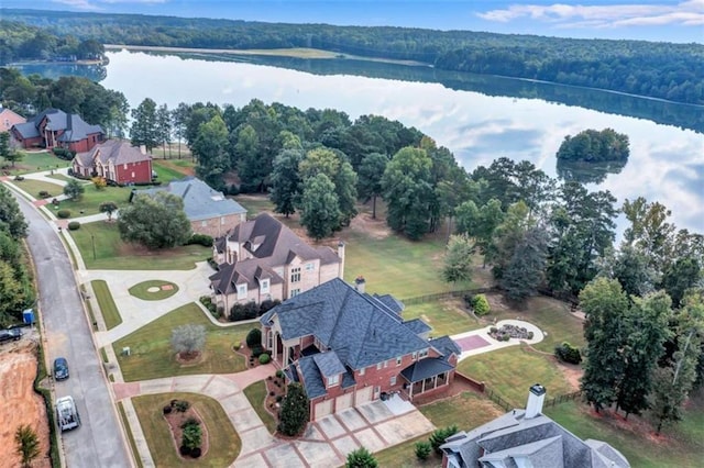 bird's eye view with a water view and a wooded view