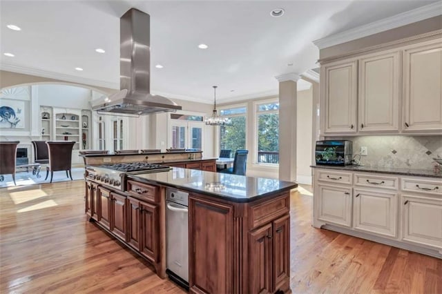 kitchen with ornamental molding, stainless steel gas cooktop, island exhaust hood, and light wood-style flooring