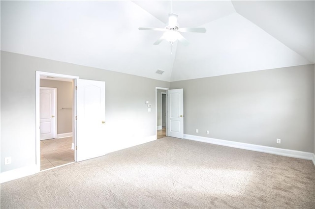 unfurnished bedroom with light colored carpet, vaulted ceiling, and ceiling fan