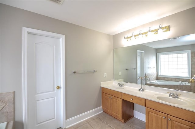 bathroom featuring a bath, tile patterned floors, and vanity