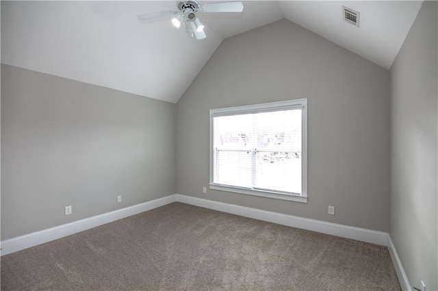 carpeted spare room with vaulted ceiling and ceiling fan