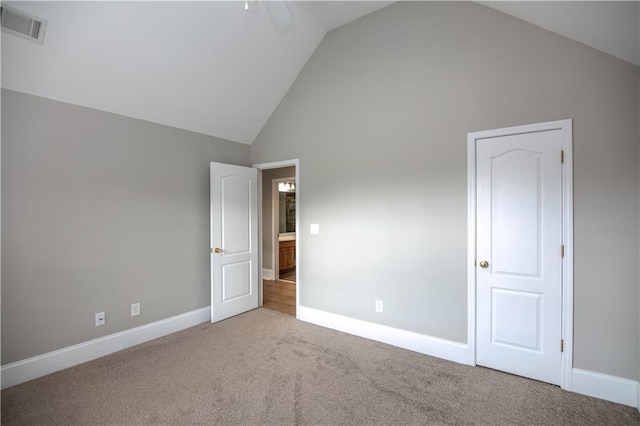 empty room featuring vaulted ceiling and carpet floors