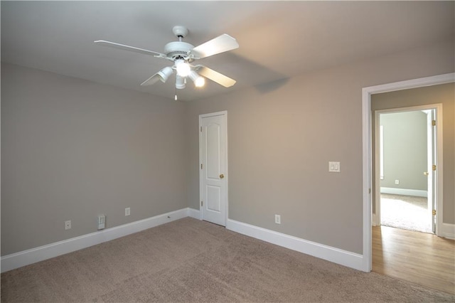 carpeted empty room featuring ceiling fan