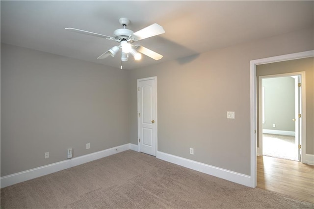 spare room featuring ceiling fan and light carpet