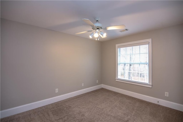 carpeted spare room with ceiling fan