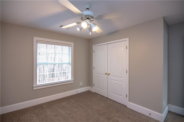 unfurnished bedroom featuring a closet, ceiling fan, and carpet floors