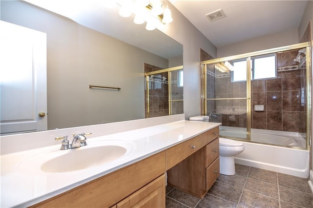 full bathroom featuring enclosed tub / shower combo, vanity, and toilet