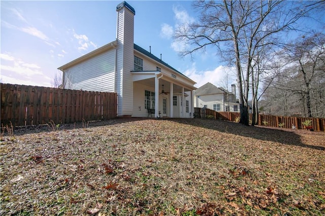 rear view of house with ceiling fan