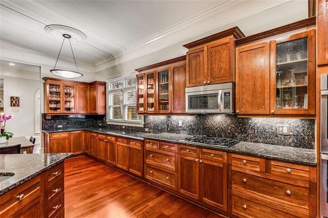 1109 Pine Grove Ave NE, Brookhaven, GA 30319 - kitchen with stainless steel microwave, gas cooktop, dark wood-type flooring, dark stone counters, and decorative backsplash