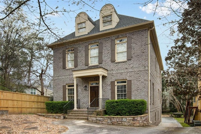 1109 Pine Grove Ave NE, Brookhaven, GA 30319 - view of front of home with brick siding, fence, and roof with shingles