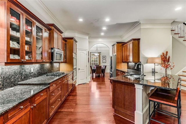 1109 Pine Grove Ave NE, Brookhaven, GA 30319 - kitchen featuring a sink, stainless steel appliances, dark wood-type flooring, glass insert cabinets, and ornamental molding