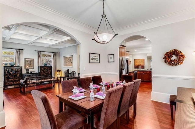 1109 Pine Grove Ave NE, Brookhaven, GA 30319 - dining area featuring wood finished floors, coffered ceiling, beamed ceiling, arched walkways, and baseboards