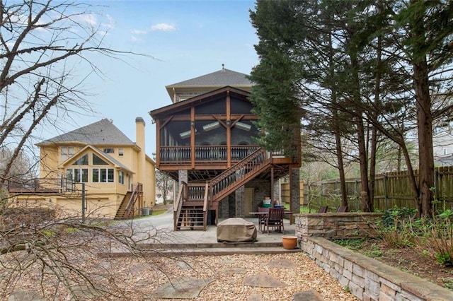 1109 Pine Grove Ave NE, Brookhaven, GA 30319 - back of house with a sunroom, stairs, a patio, and fence