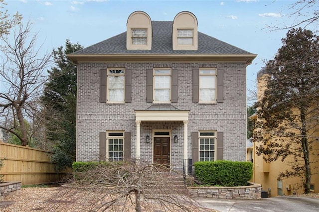1109 Pine Grove Ave NE, Brookhaven, GA 30319 - view of front of home featuring brick siding, fence, and roof with shingles