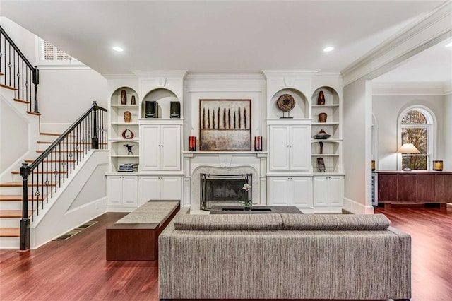1109 Pine Grove Ave NE, Brookhaven, GA 30319 - living area with dark wood-style floors, a fireplace, stairs, crown molding, and baseboards