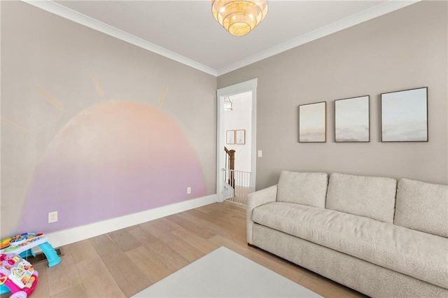 living room with wood finished floors, baseboards, and ornamental molding