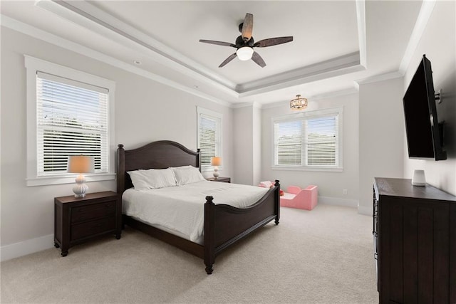 bedroom with a raised ceiling, a ceiling fan, ornamental molding, baseboards, and light colored carpet