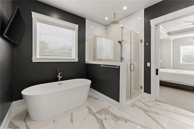 full bathroom featuring a shower stall, marble finish floor, baseboards, a freestanding tub, and ensuite bathroom