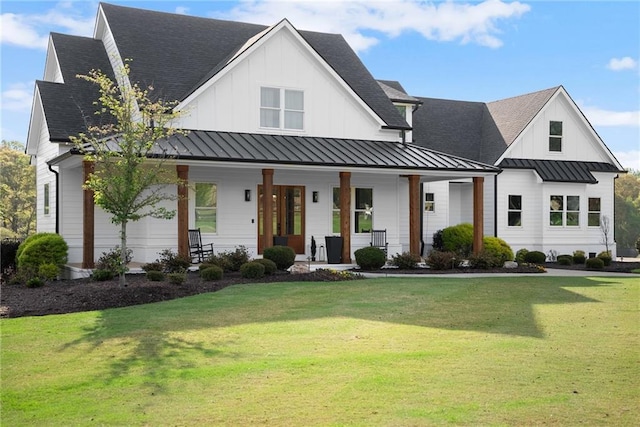 modern farmhouse style home featuring a porch, a standing seam roof, a front lawn, and board and batten siding