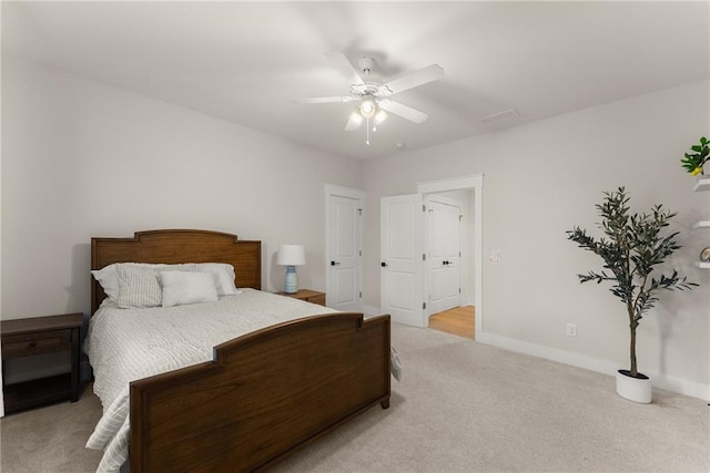 carpeted bedroom with ceiling fan, baseboards, and visible vents