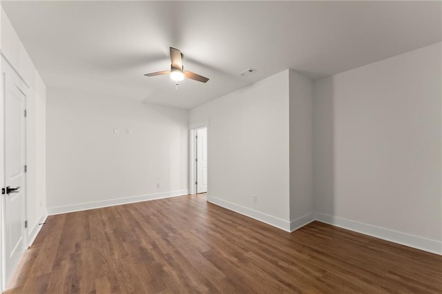 unfurnished room with baseboards, wood finished floors, visible vents, and a ceiling fan
